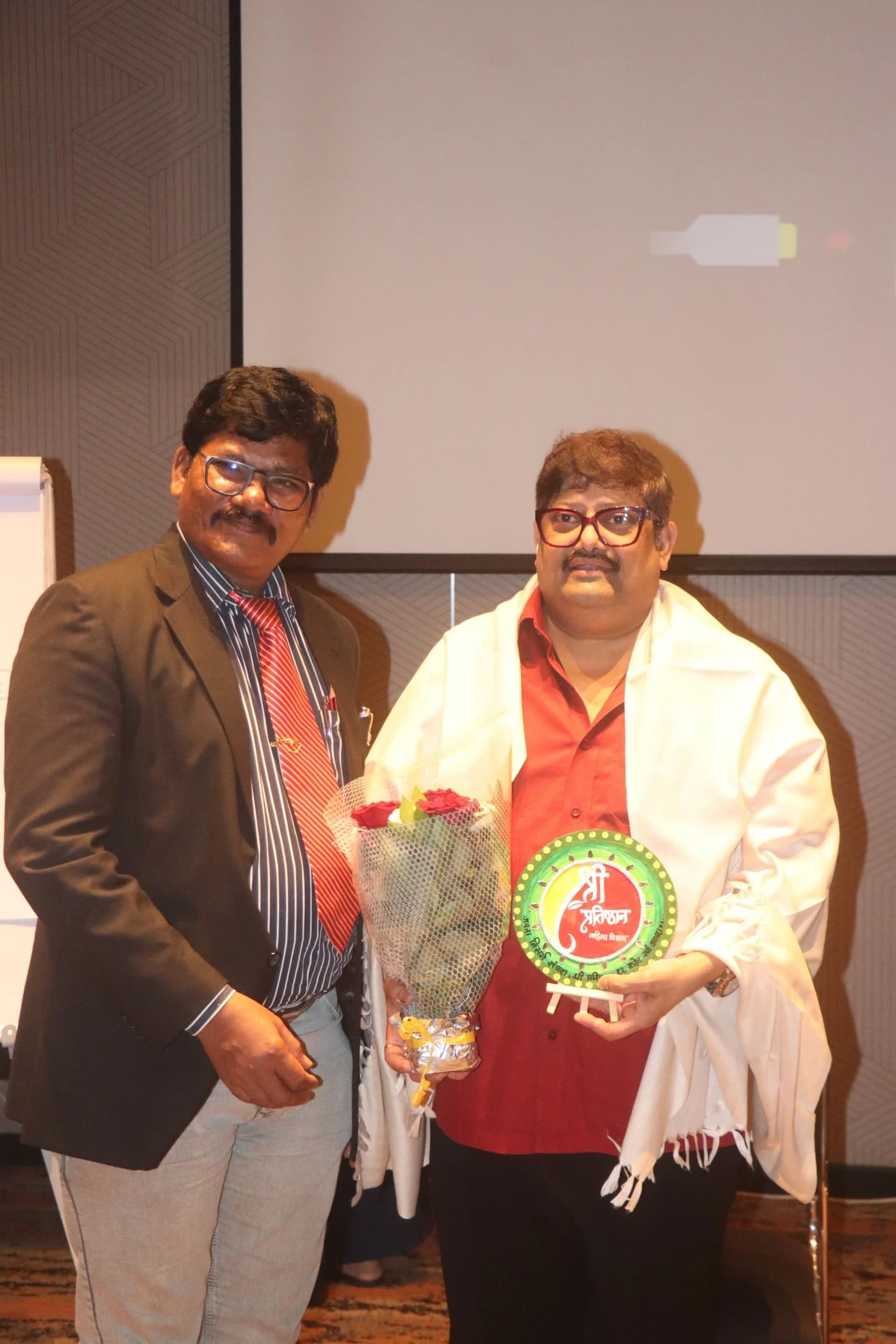 Rajesh Kaithwas being felicitated with a shawl and memento
